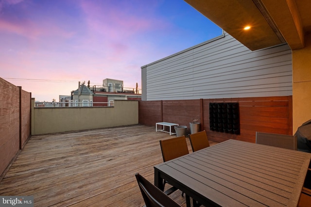 deck at dusk with outdoor dining area