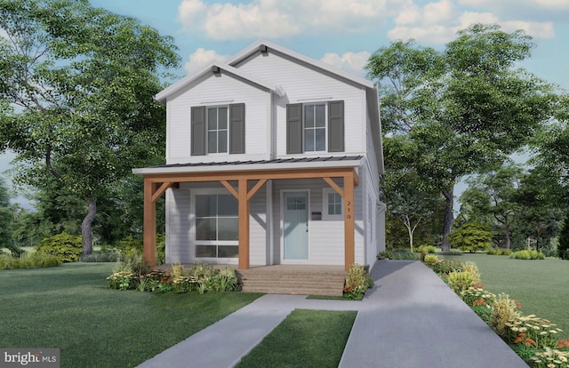 view of front facade featuring a porch, metal roof, and a front lawn