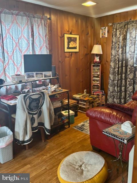 home office featuring wood walls and wood finished floors