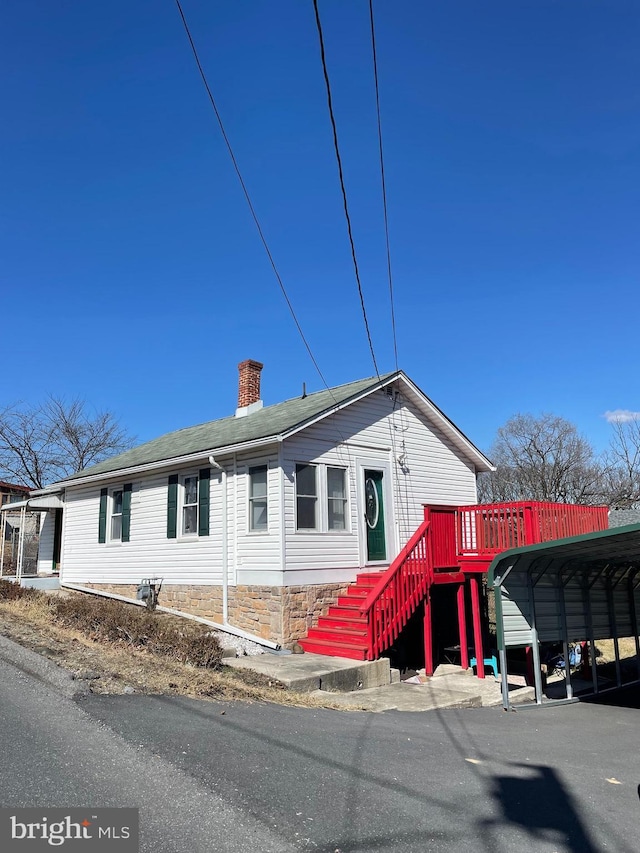 view of front of property featuring a chimney and stairs