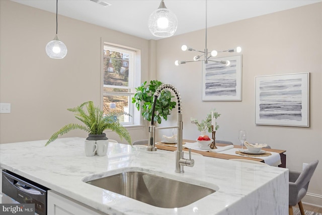 kitchen with plenty of natural light, dishwashing machine, pendant lighting, and a sink