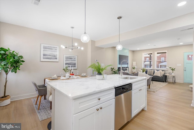 kitchen featuring visible vents, a sink, stainless steel dishwasher, open floor plan, and light wood-style floors