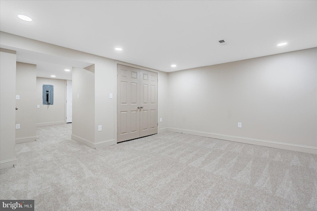 finished basement with electric panel, carpet flooring, recessed lighting, and baseboards