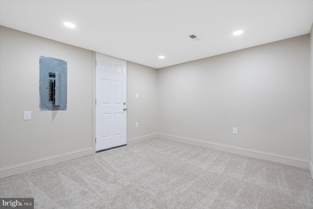 empty room featuring visible vents, baseboards, carpet floors, electric panel, and recessed lighting