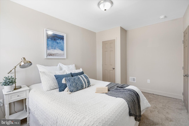 carpeted bedroom featuring baseboards and visible vents