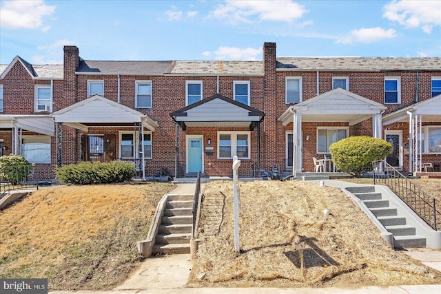 townhome / multi-family property with brick siding