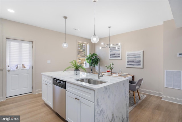 kitchen featuring visible vents, light wood-style flooring, stainless steel dishwasher, white cabinetry, and a sink