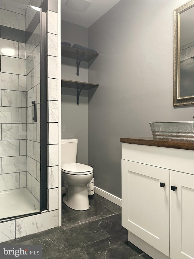 full bath with vanity, a shower stall, toilet, and marble finish floor