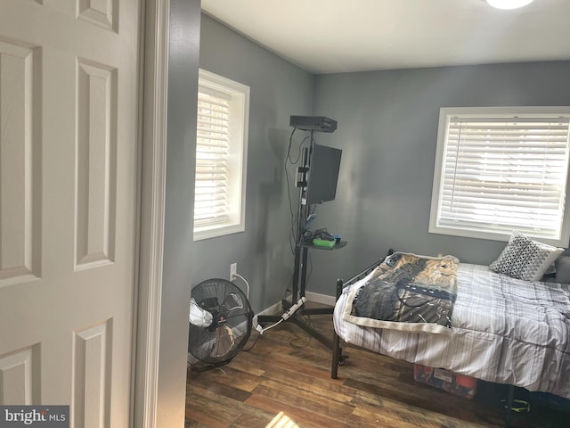 bedroom with baseboards and dark wood finished floors