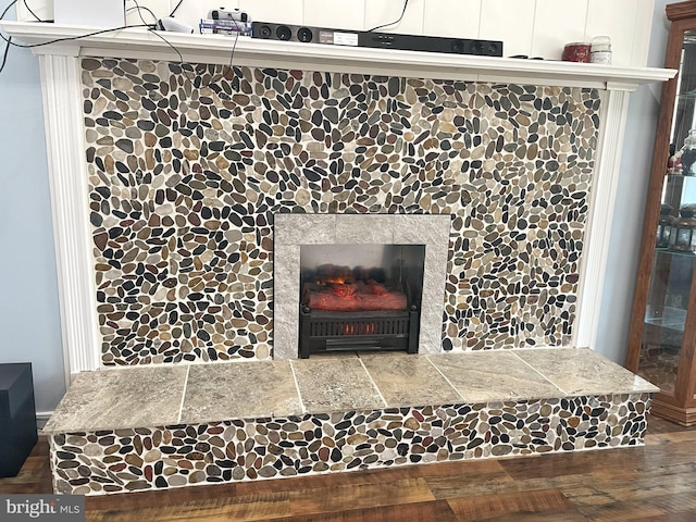 interior details with wood finished floors and a fireplace