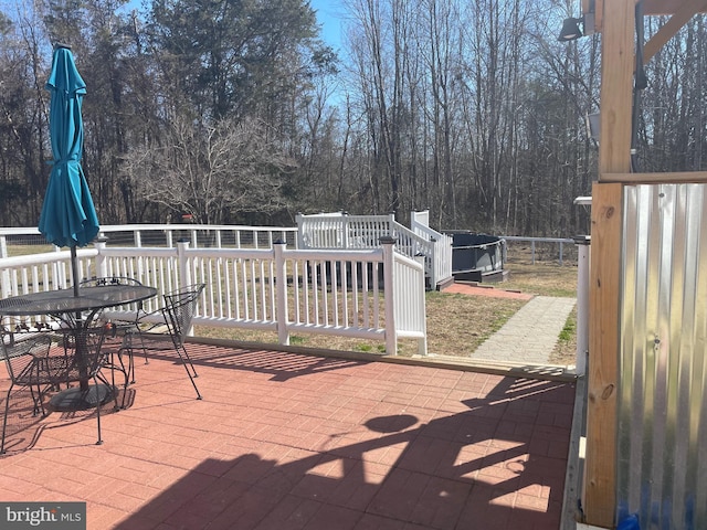 view of patio with outdoor dining space and a deck