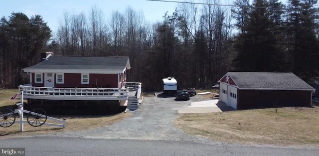 exterior space featuring a garage and an outbuilding