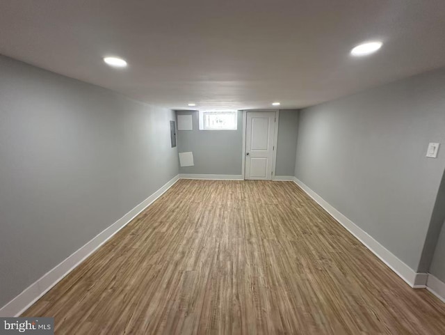 below grade area with baseboards, wood finished floors, and recessed lighting