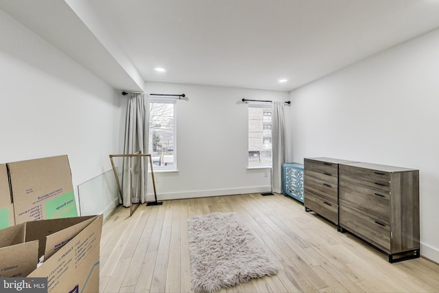 interior space with light wood-type flooring, baseboards, and recessed lighting