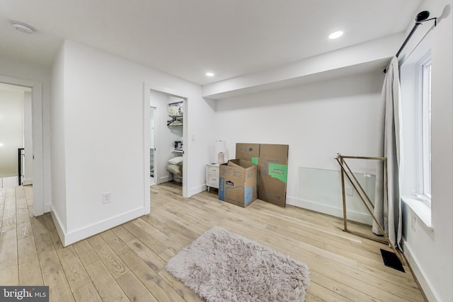 below grade area featuring recessed lighting, light wood-type flooring, and baseboards