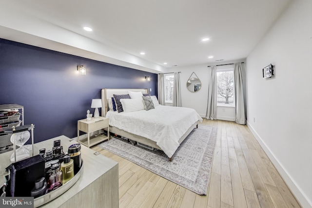 bedroom featuring light wood-type flooring, baseboards, and recessed lighting