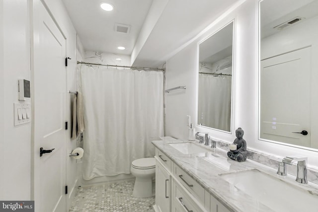 full bath featuring visible vents, a sink, and double vanity