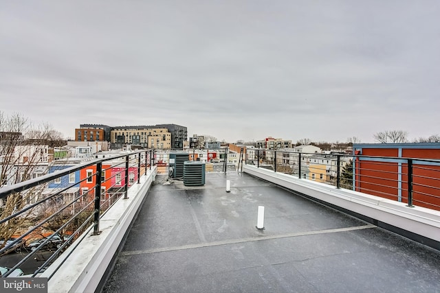 balcony with a view of city and central AC unit