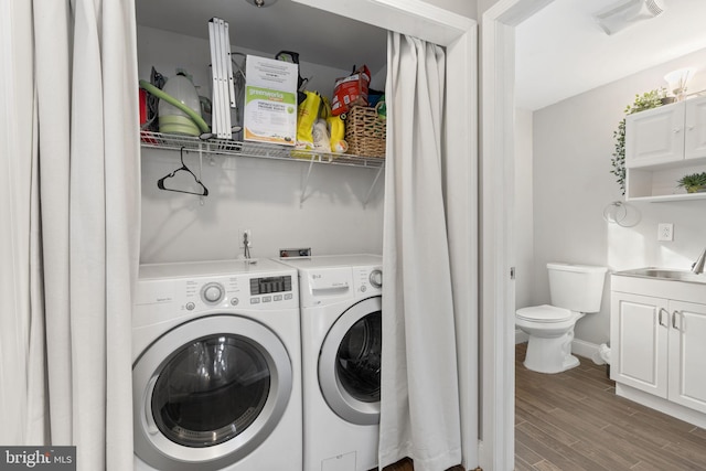 laundry area featuring laundry area, visible vents, wood finished floors, separate washer and dryer, and a sink