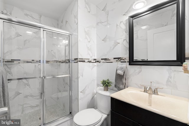 bathroom featuring a marble finish shower, decorative backsplash, toilet, vanity, and tile walls