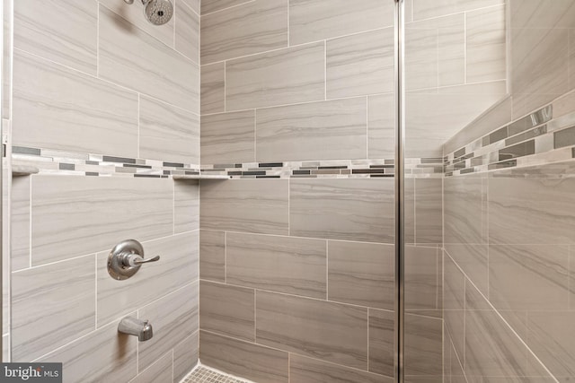 bathroom with a tile shower