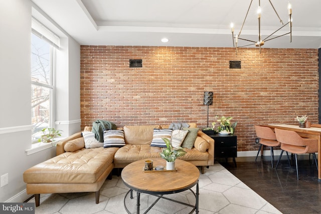 living room with brick wall and baseboards