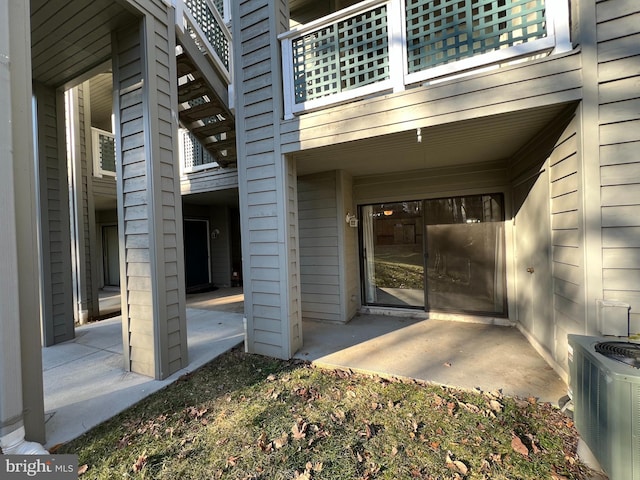 entrance to property featuring a patio and central air condition unit