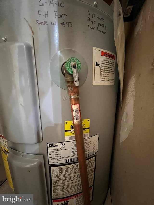 utility room featuring electric water heater