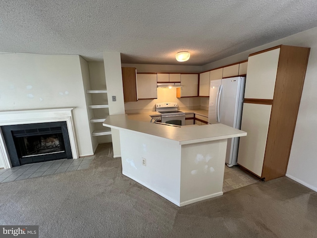 kitchen featuring light carpet, white appliances, light countertops, and a peninsula