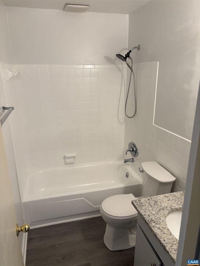 full bath featuring bathtub / shower combination, vanity, toilet, and wood finished floors