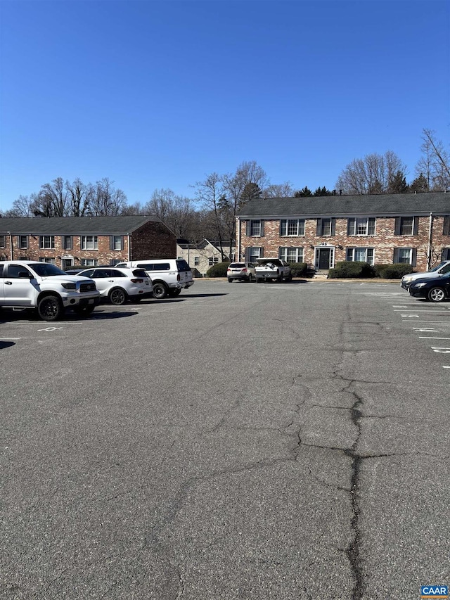 uncovered parking lot featuring a residential view