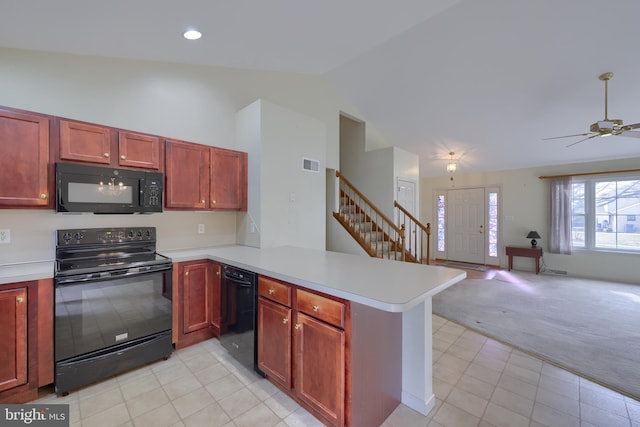 kitchen featuring light countertops, open floor plan, light carpet, a peninsula, and black appliances