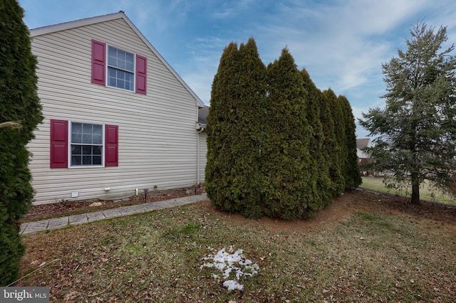 view of side of home with a lawn