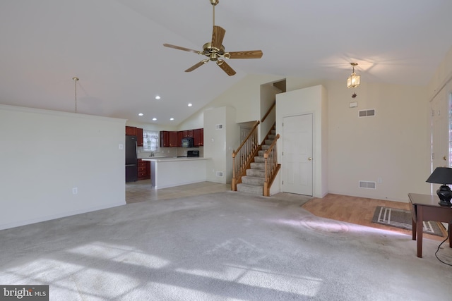 unfurnished living room featuring high vaulted ceiling, light colored carpet, visible vents, and stairs