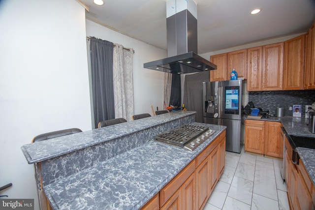 kitchen featuring decorative backsplash, a kitchen breakfast bar, marble finish floor, island exhaust hood, and stainless steel appliances