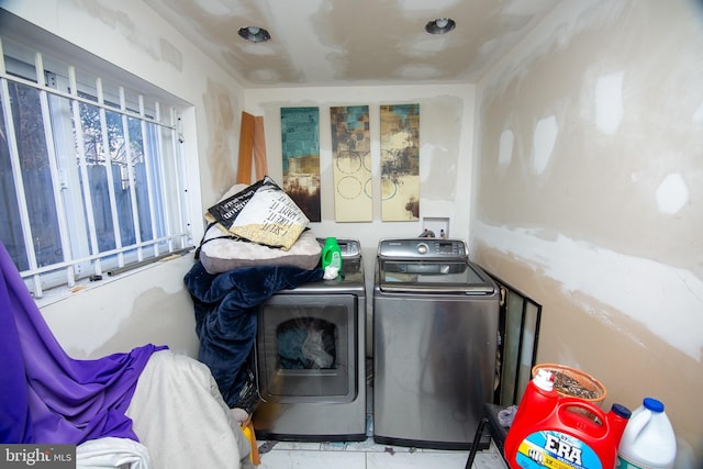 clothes washing area with washing machine and clothes dryer