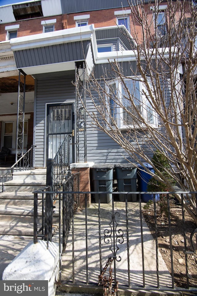 entrance to property featuring brick siding