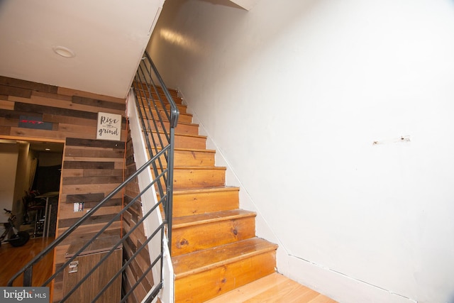 stairs featuring wood finished floors