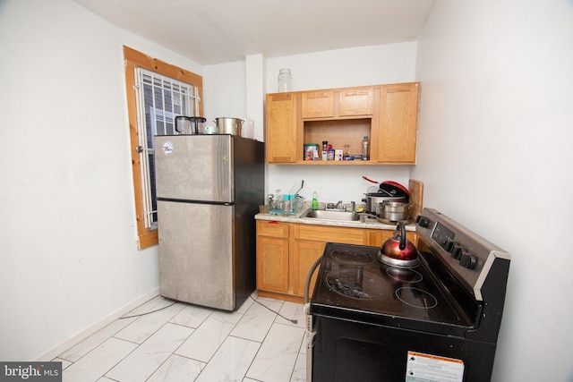 kitchen featuring range with electric cooktop, freestanding refrigerator, light countertops, open shelves, and a sink