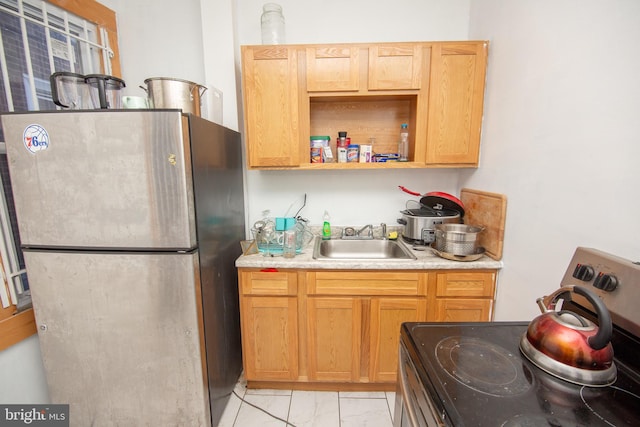 kitchen featuring appliances with stainless steel finishes, marble finish floor, light countertops, open shelves, and a sink