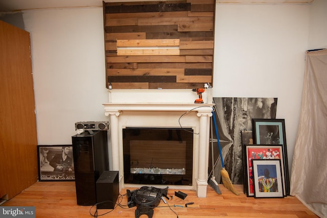 interior space featuring wood finished floors and a glass covered fireplace