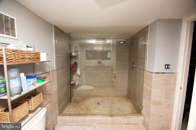 full bathroom featuring a stall shower and tile walls