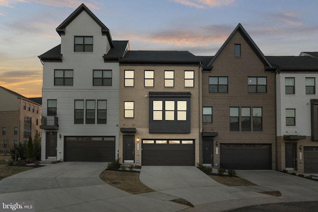 multi unit property with concrete driveway and an attached garage