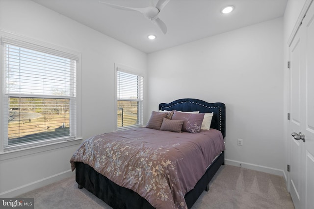 carpeted bedroom with ceiling fan, baseboards, a closet, and recessed lighting