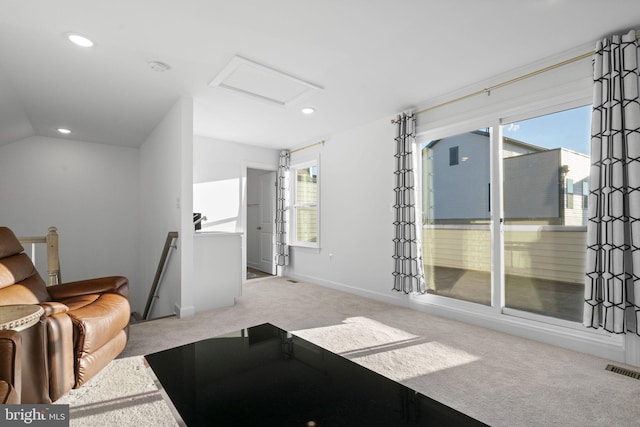 living area featuring attic access, visible vents, lofted ceiling, carpet, and recessed lighting