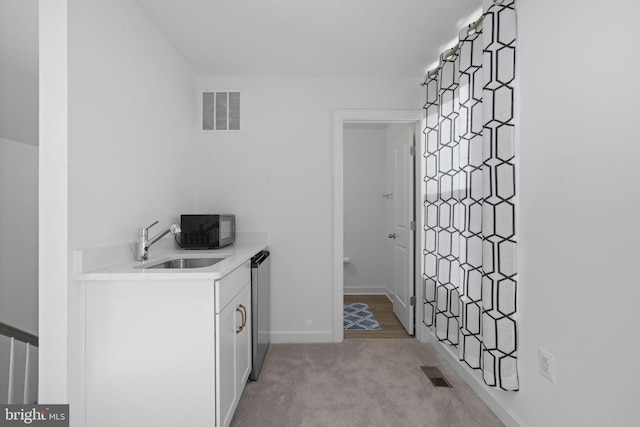 interior space featuring visible vents, a sink, and baseboards