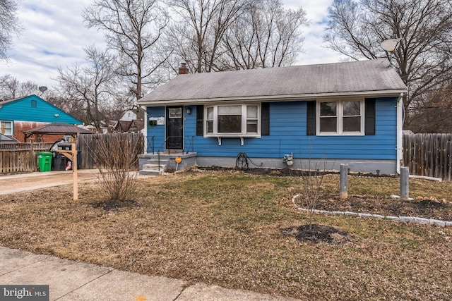 view of front of house with a gazebo, a chimney, fence, and driveway