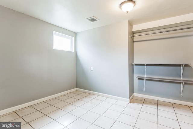 spare room with visible vents, baseboards, and light tile patterned flooring