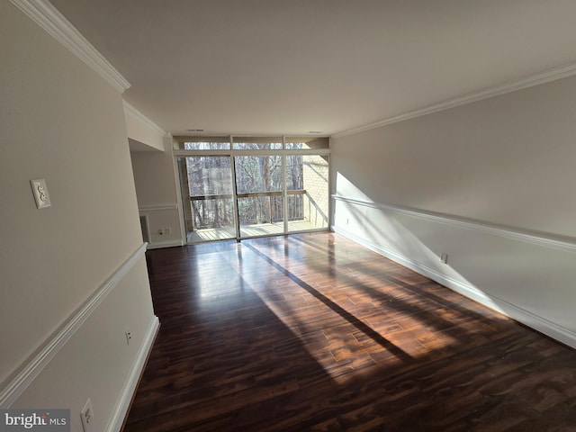 empty room with crown molding and wood finished floors