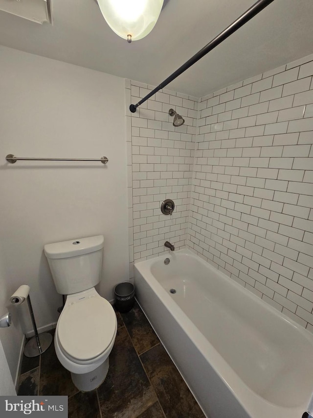 bathroom featuring washtub / shower combination and toilet